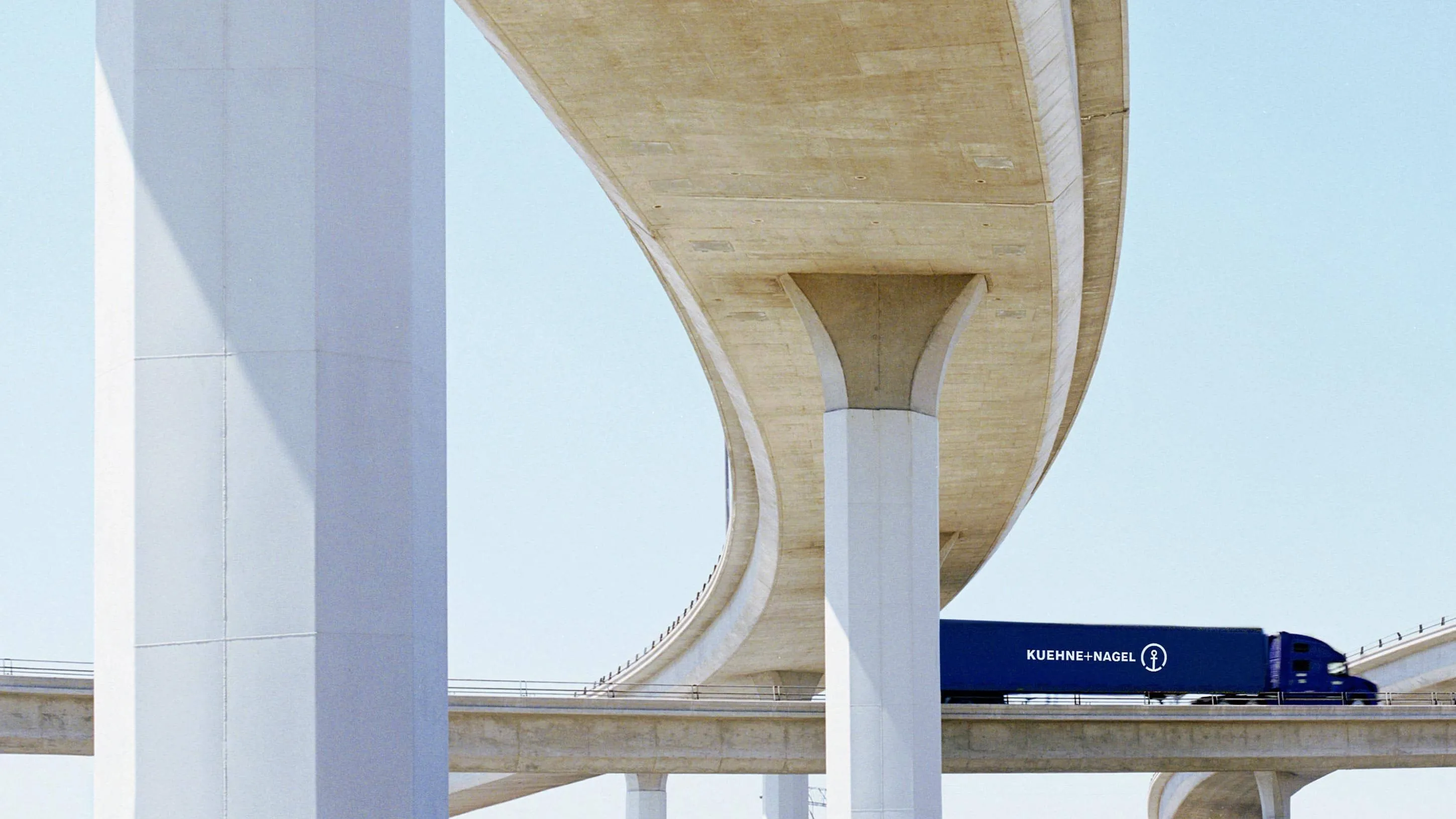Side view of a Kuehne+Nagel truck on the bridge