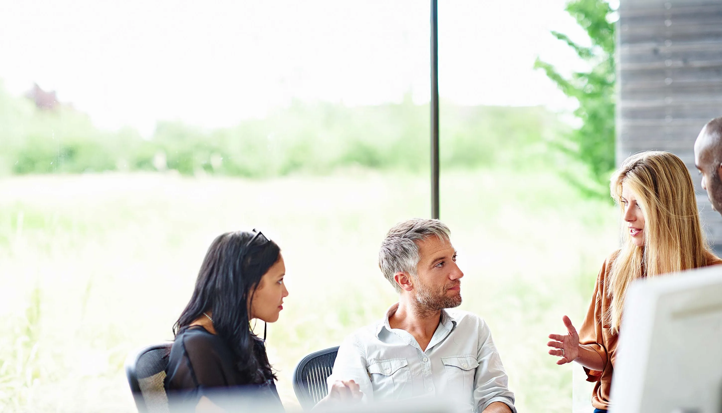 Group of people in an office meeting with blurred faces